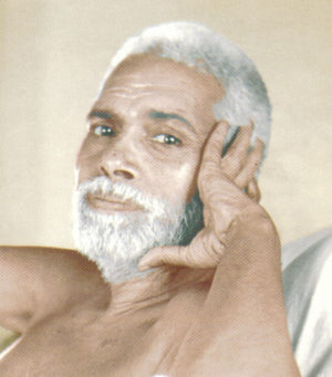 Photo of Ramana Maharshi supporting head with left hand in color