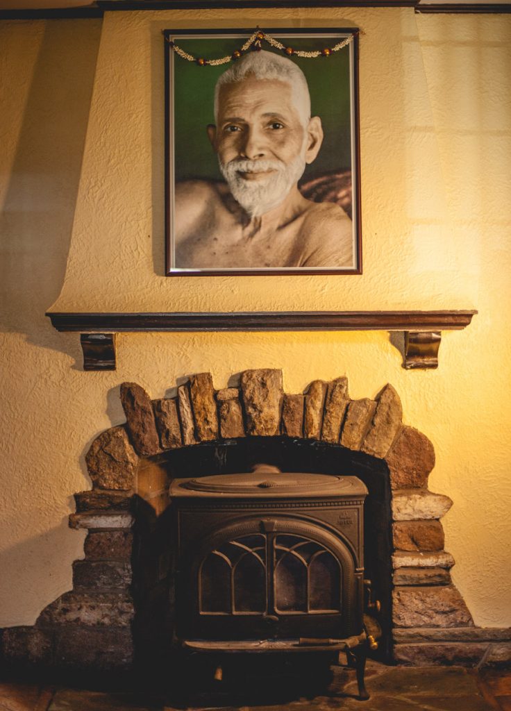 Arunachala Ashrama. Fireplace with Ramana photo.