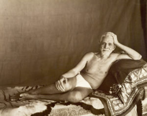 Photo of Sri Bhagavan reclining on couch in Sepia