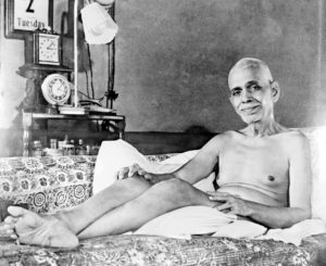 Photo of Ramana Maharshi cropped reclining on couch in old hall photo from feet 2nd Dec 1947 close up in black and white